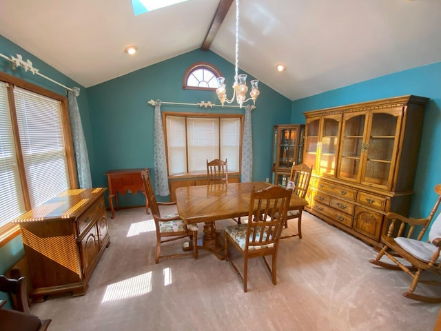 carpeted dining room featuring a notable chandelier and vaulted ceiling with beams