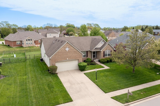 view of front of property with driveway, roof with shingles, a garage, brick siding, and fence
