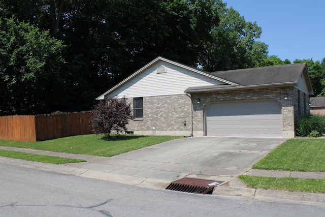 108 Esther Dr, Lewisburg, OH 45338 - ranch-style house with brick siding, driveway, and a garage