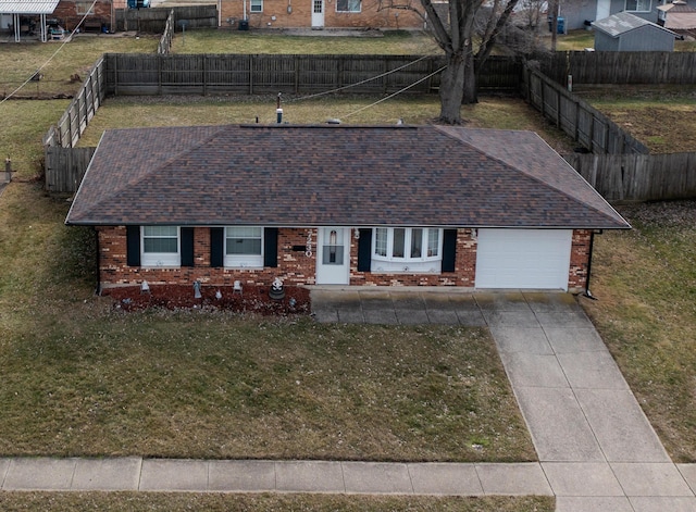 single story home with an attached garage, a front lawn, concrete driveway, and brick siding