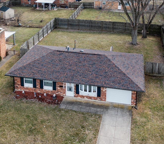 view of front of home featuring a garage, a front yard, concrete driveway, and brick siding