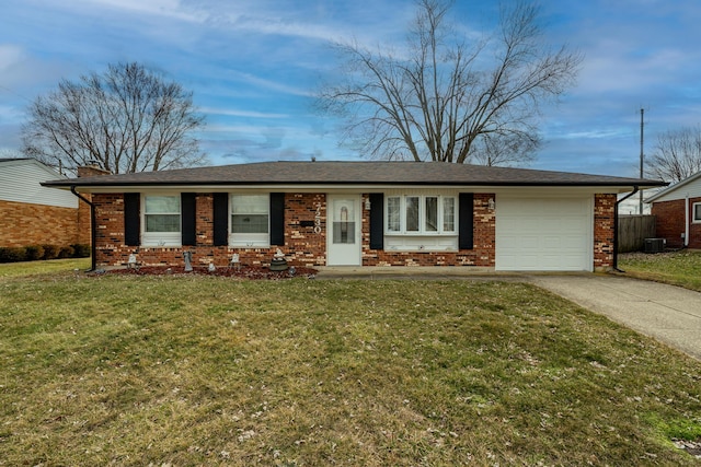 single story home featuring a garage, a front lawn, and brick siding