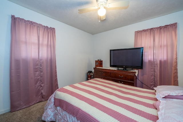 bedroom with carpet, a ceiling fan, and a textured ceiling