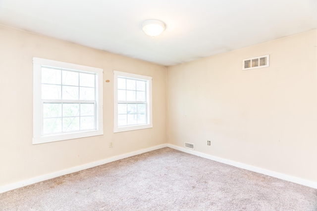 carpeted spare room with baseboards