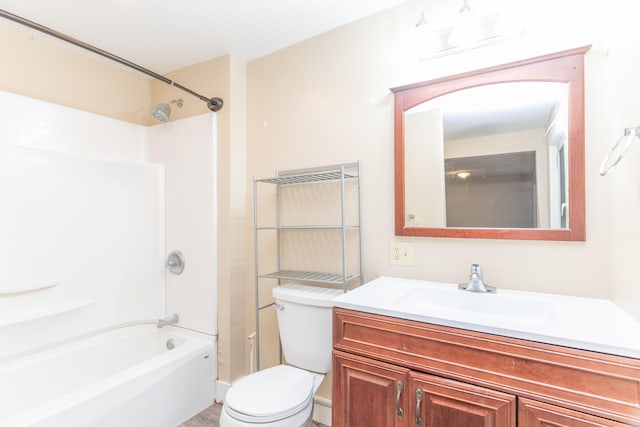 bathroom featuring  shower combination, vanity, and toilet