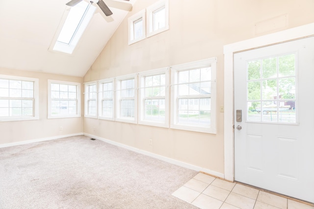 unfurnished sunroom featuring a skylight and vaulted ceiling