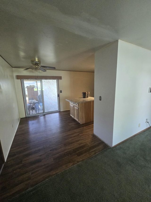 1006 Mayfield Dr, Troy, OH 45373 - unfurnished living room featuring dark wood-style floors, ceiling fan, and baseboards