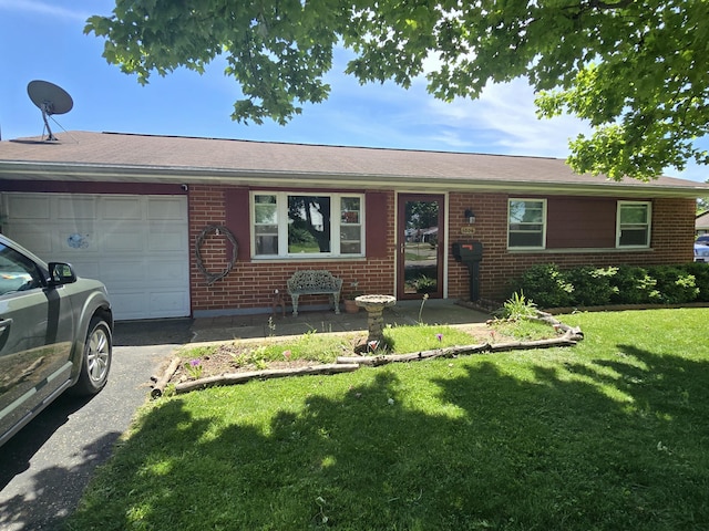 1006 Mayfield Dr, Troy, OH 45373 - ranch-style home featuring an attached garage, brick siding, and a front lawn