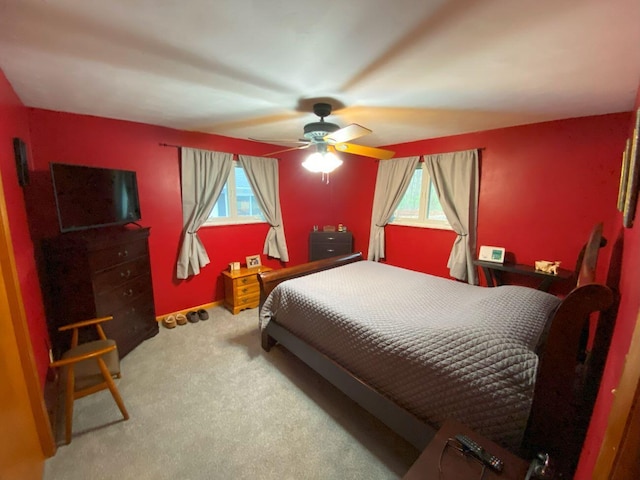 bedroom featuring carpet floors, ceiling fan, and multiple windows