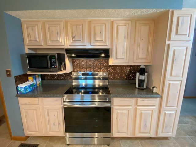 kitchen featuring stainless steel appliances, ventilation hood, decorative backsplash, and dark countertops