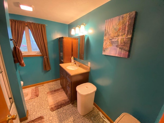 bathroom with visible vents, baseboards, and vanity
