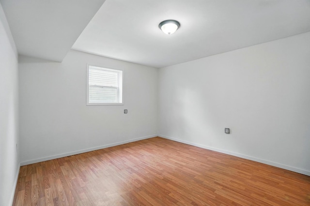 empty room with wood finished floors and baseboards