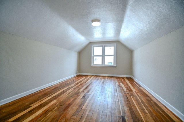 422 New St, Sidney, OH 45365 - bonus room featuring a textured ceiling, dark hardwood / wood-style flooring, and lofted ceiling