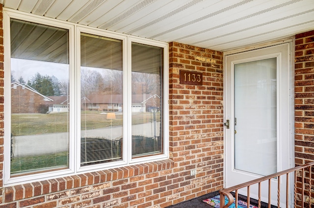 property entrance with brick siding