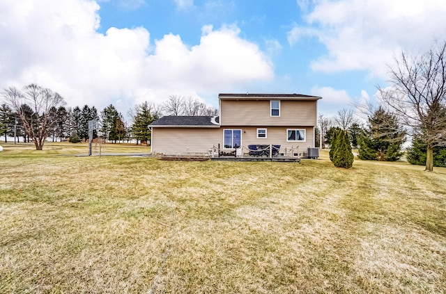 back of property with central air condition unit, a wooden deck, and a yard