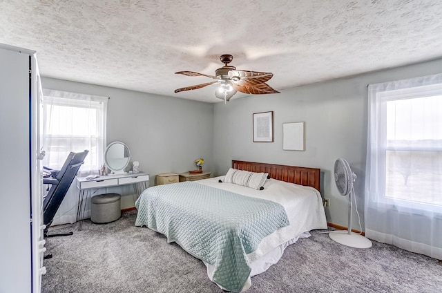 carpeted bedroom featuring a ceiling fan, a textured ceiling, and baseboards