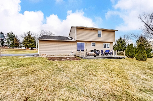 back of property featuring a yard and a deck