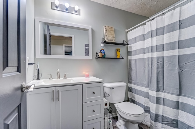 bathroom featuring a textured ceiling, vanity, toilet, and a shower with curtain