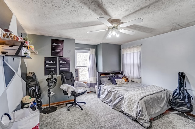 bedroom with carpet, ceiling fan, and a textured ceiling