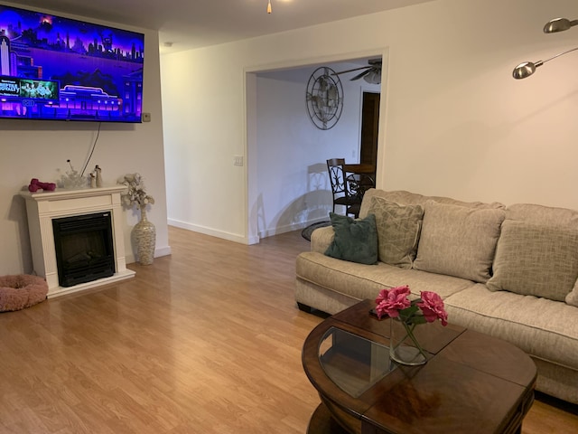 6645 Oak Dr, Celina, OH 45822 - living room featuring wood finished floors, ceiling fan, and a fireplace with raised hearth