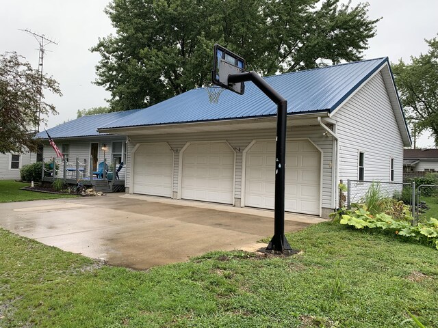 6645 Oak Dr, Celina, OH 45822 - view of home's exterior featuring a metal roof and an attached garage