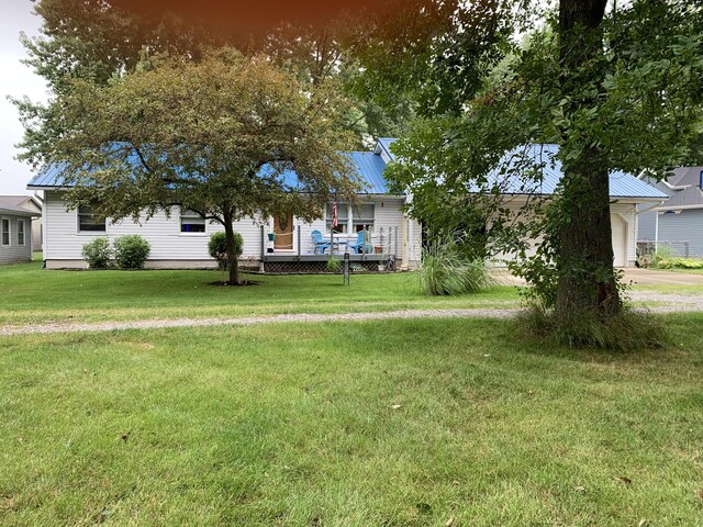 6645 Oak Dr, Celina, OH 45822 - view of front of property with a front lawn, a garage, and a metal roof