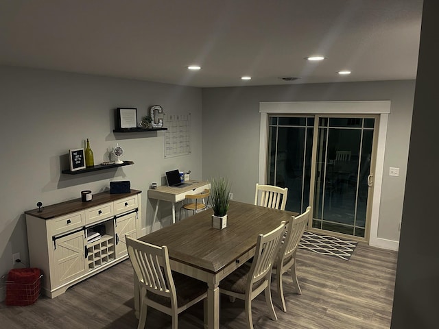 dining space with dark wood-style floors, baseboards, and recessed lighting