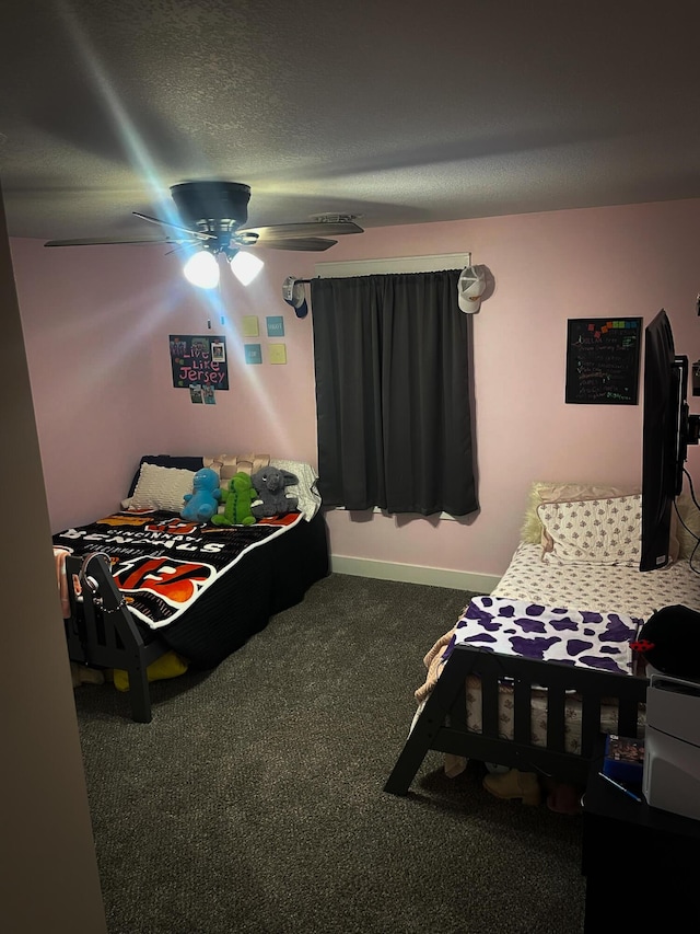 carpeted bedroom featuring a textured ceiling, a ceiling fan, and baseboards