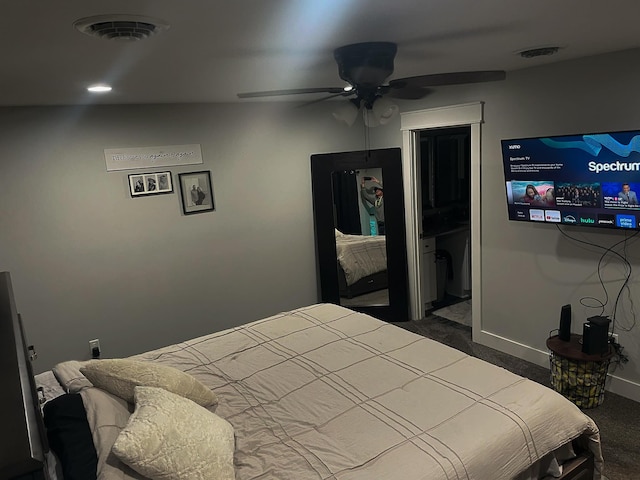 bedroom with a ceiling fan, visible vents, dark carpet, and baseboards