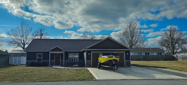 view of front of home featuring driveway, a garage, stone siding, fence, and a front yard