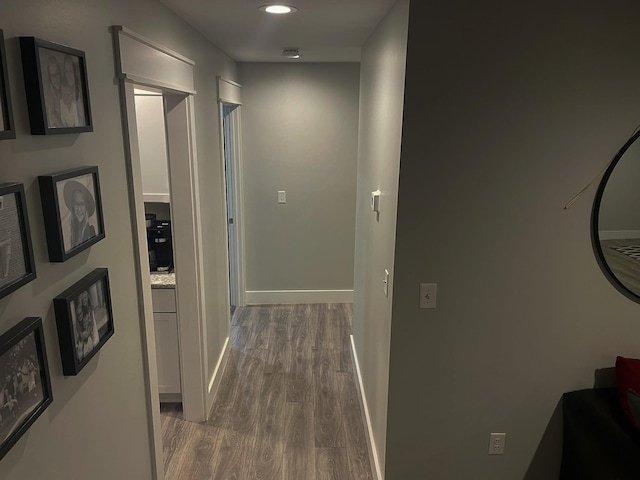 hall featuring recessed lighting, wood finished floors, and baseboards