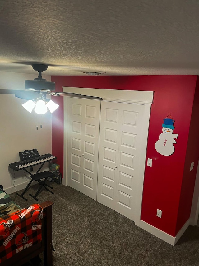 interior space with baseboards, visible vents, and a textured ceiling