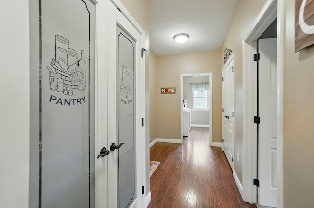 hallway with dark wood-style flooring and baseboards