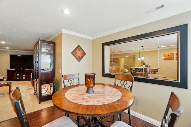 dining room with visible vents, baseboards, ornamental molding, recessed lighting, and wood finished floors