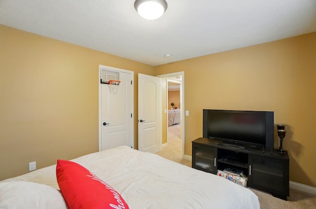 carpeted bedroom featuring baseboards