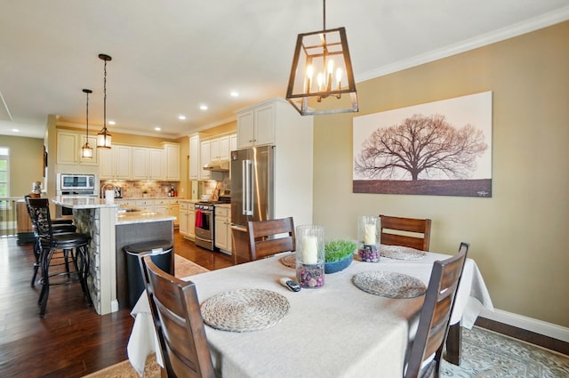 dining space with recessed lighting, dark wood-style flooring, baseboards, and ornamental molding