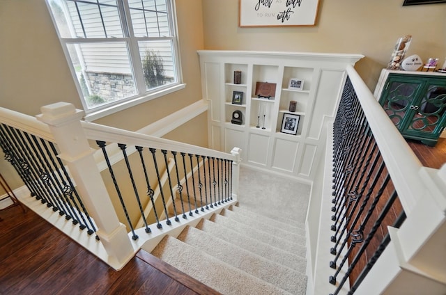 staircase featuring wood finished floors