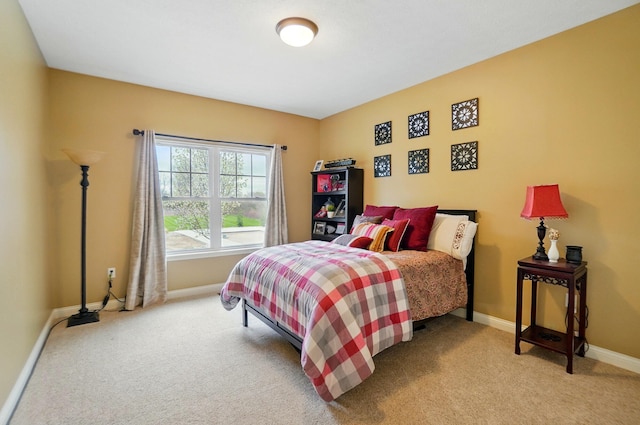 bedroom featuring baseboards and carpet