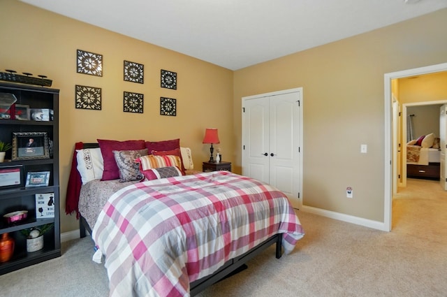 bedroom featuring a closet, carpet, and baseboards