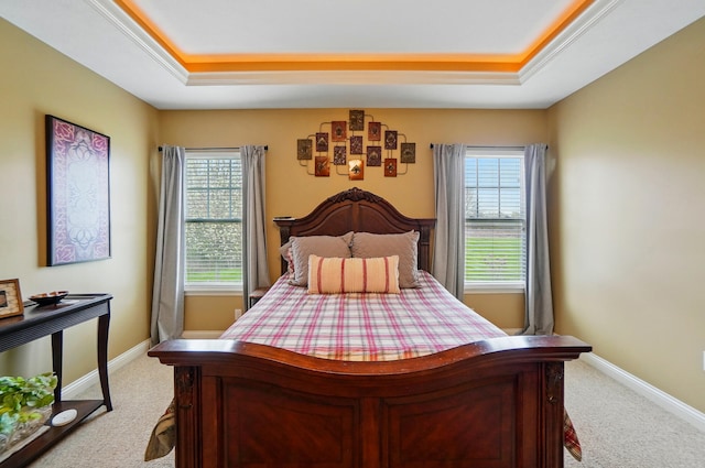 bedroom with a raised ceiling, carpet flooring, and baseboards