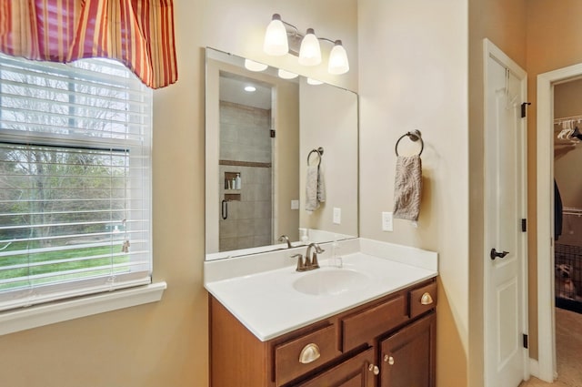 full bath with a spacious closet, plenty of natural light, and vanity