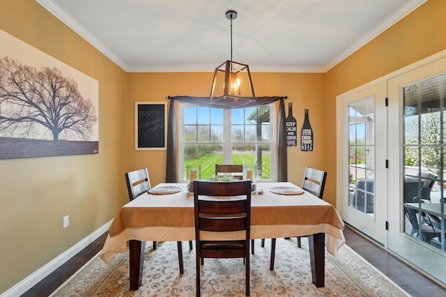 dining space with a healthy amount of sunlight, crown molding, and wood finished floors