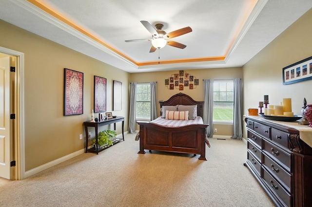 bedroom with ceiling fan, light colored carpet, baseboards, and a raised ceiling