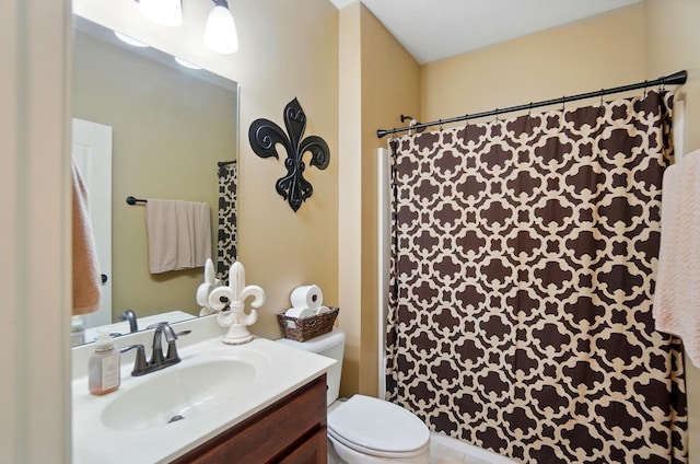 bathroom with toilet, vanity, and a shower with curtain