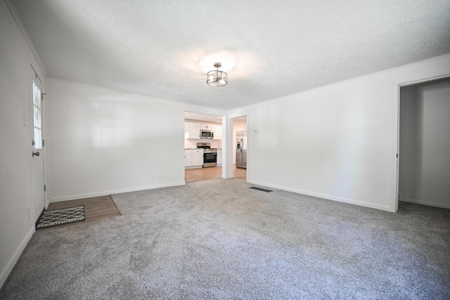 8095 N Lena-Palestine Rd, Conover, OH 45317 - unfurnished room with light colored carpet, a textured ceiling, and ornamental molding