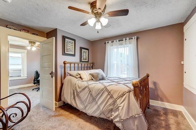 bedroom featuring light colored carpet, a textured ceiling, and ceiling fan