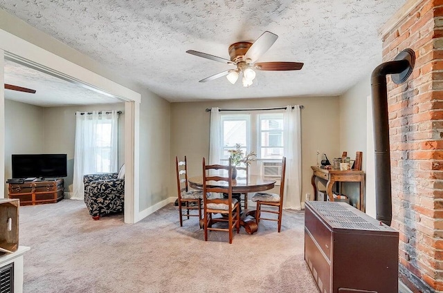 dining area with light colored carpet, a healthy amount of sunlight, and a textured ceiling