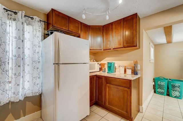 kitchen with light tile patterned floors and white appliances