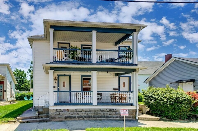 view of front of house with a balcony and covered porch