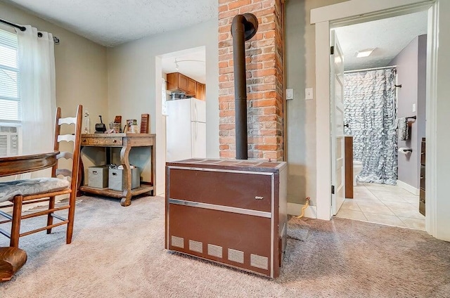 office with light carpet, a textured ceiling, and a wood stove